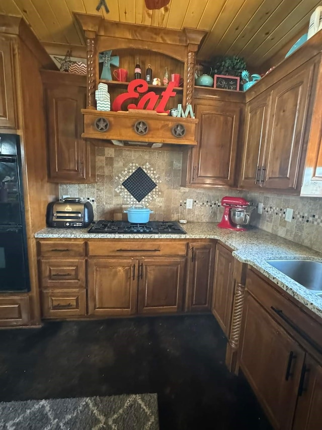 kitchen featuring black appliances, wood ceiling, light stone counters, and custom exhaust hood