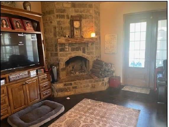 living room with a stone fireplace