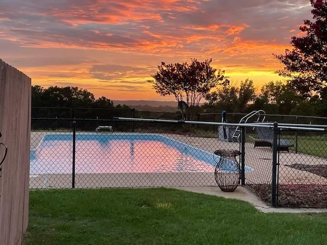 view of pool at dusk