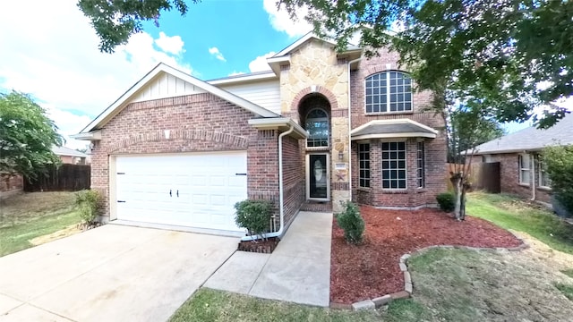 traditional-style house featuring brick siding, an attached garage, board and batten siding, fence, and driveway