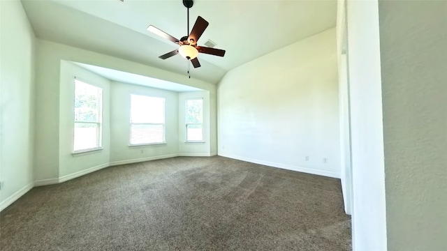 carpeted empty room with ceiling fan and vaulted ceiling