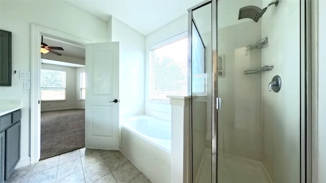 bathroom with tile patterned flooring, a garden tub, a shower stall, and vanity