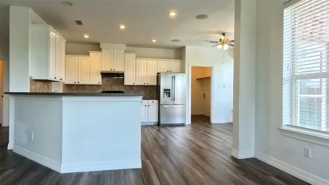 kitchen with white cabinetry, plenty of natural light, and stainless steel refrigerator with ice dispenser