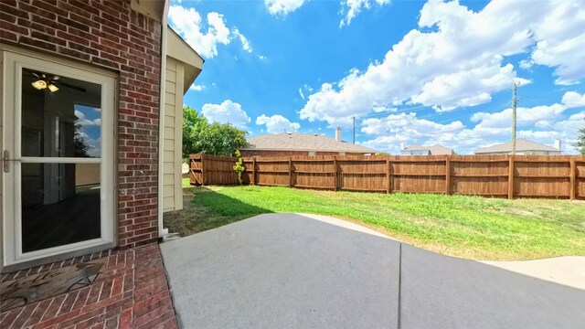 view of yard featuring fence and a patio