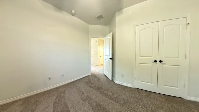 unfurnished bedroom featuring a closet and carpet floors