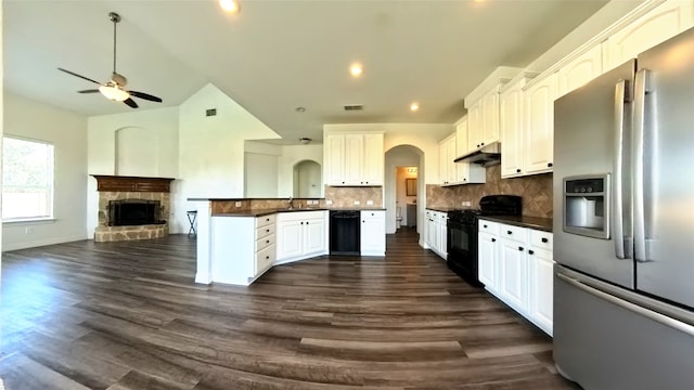 kitchen with white cabinetry, black appliances, and dark hardwood / wood-style flooring