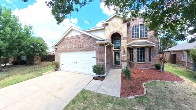 traditional-style house with a garage, driveway, brick siding, stone siding, and a front yard