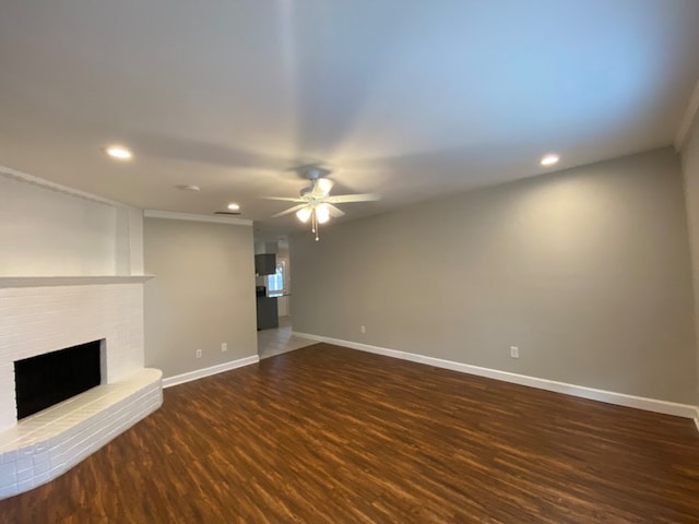 unfurnished living room with a fireplace, hardwood / wood-style floors, and ceiling fan