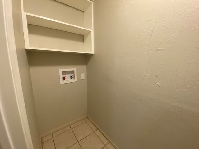 laundry room featuring hookup for a washing machine and light tile patterned floors