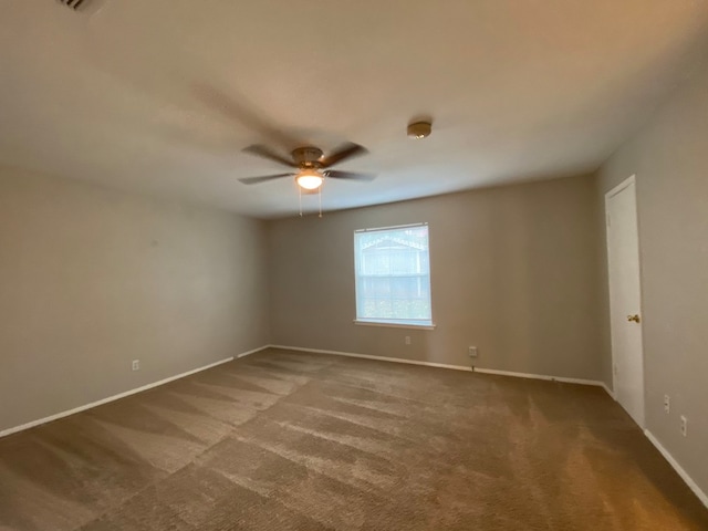 empty room with carpet and ceiling fan