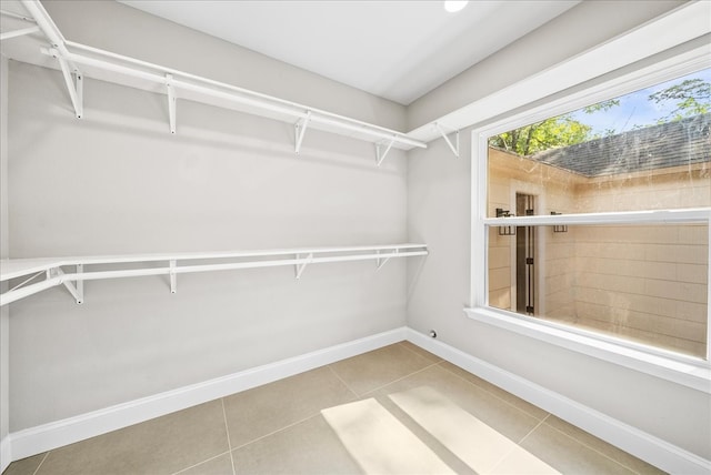 spacious closet featuring light tile patterned flooring