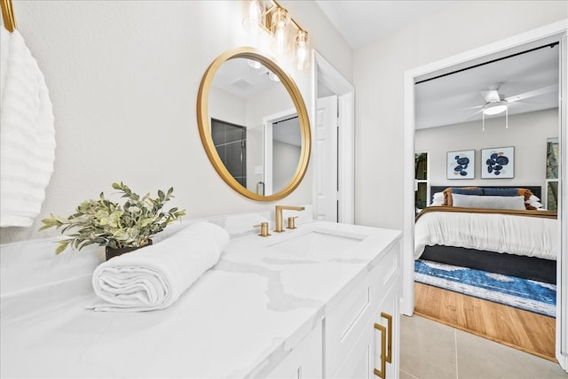 bathroom featuring tile patterned floors, ceiling fan, and vanity