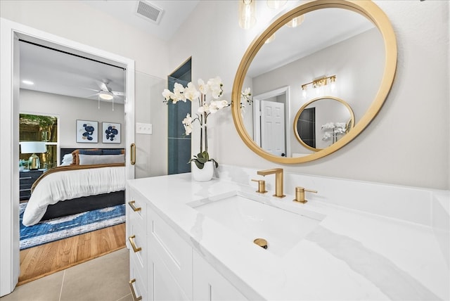 bathroom with vanity, ceiling fan, and tile patterned flooring