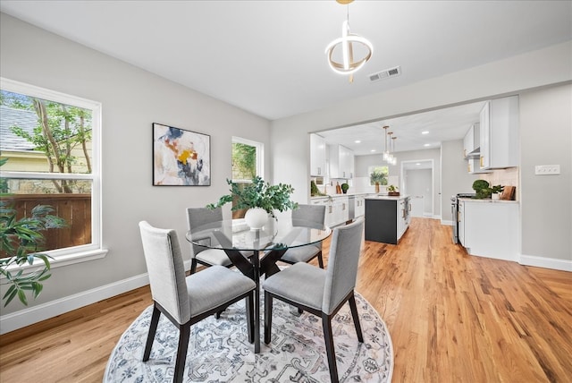 dining space with light wood-type flooring