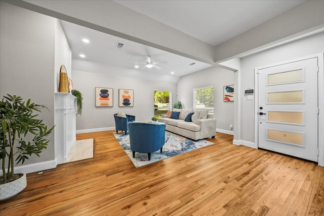 living room with light hardwood / wood-style flooring and ceiling fan