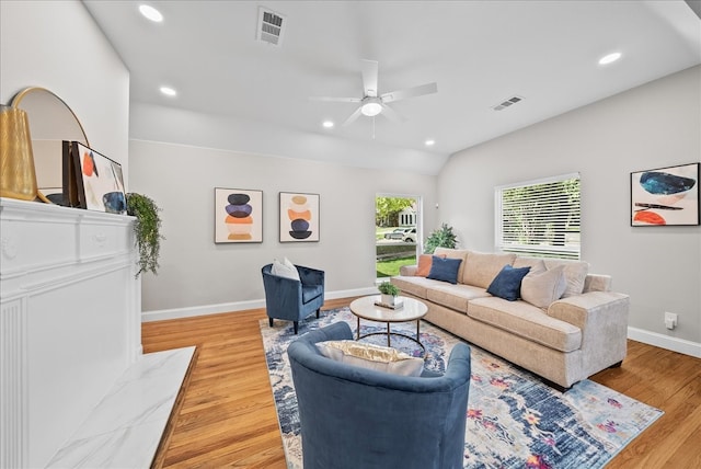 living room with lofted ceiling, light hardwood / wood-style flooring, and ceiling fan