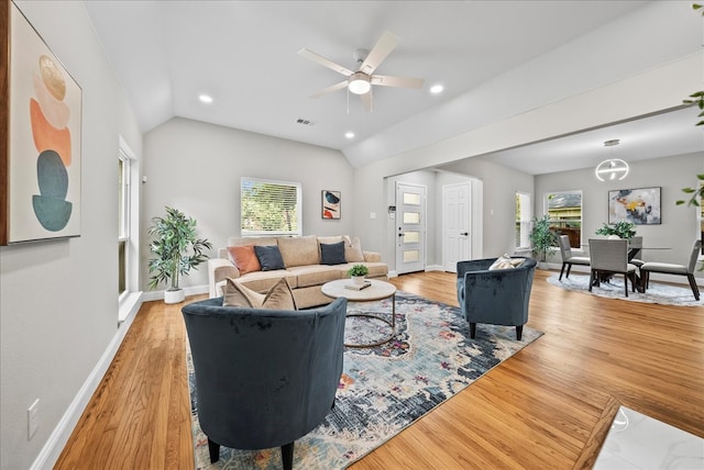 living room with lofted ceiling, ceiling fan, and light hardwood / wood-style flooring