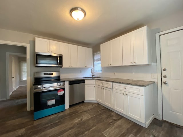 kitchen featuring dark hardwood / wood-style flooring, appliances with stainless steel finishes, and white cabinetry