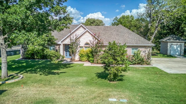 view of front of property with a storage unit and a front lawn