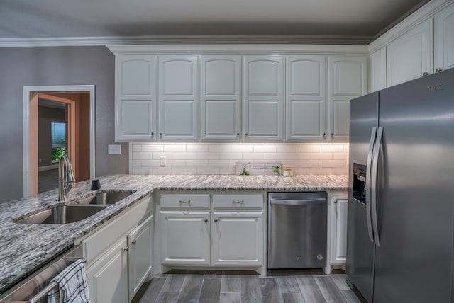 kitchen featuring light stone counters, sink, appliances with stainless steel finishes, and white cabinets