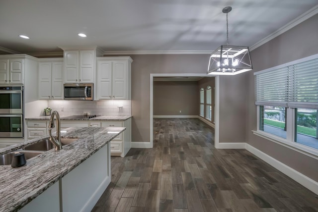 kitchen with a chandelier, decorative light fixtures, sink, light stone countertops, and appliances with stainless steel finishes