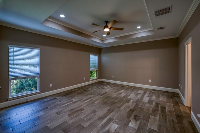 unfurnished room with a raised ceiling, wood-type flooring, and ceiling fan