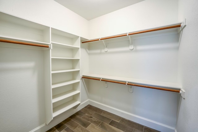 walk in closet featuring dark wood-type flooring