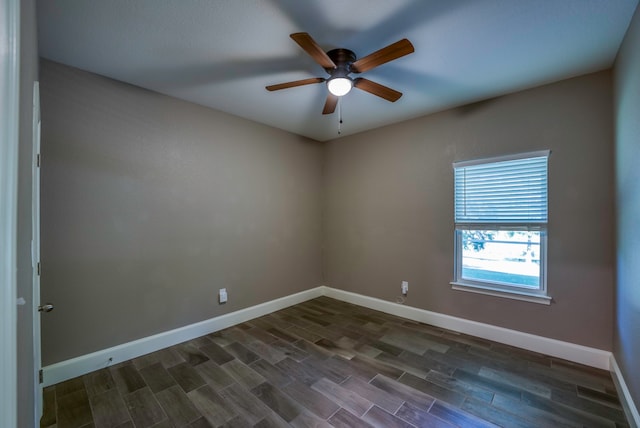 spare room featuring ceiling fan and dark hardwood / wood-style flooring