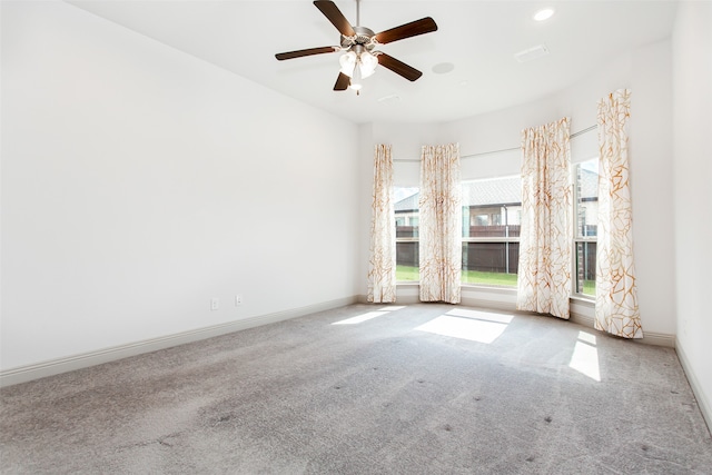 carpeted spare room with ceiling fan