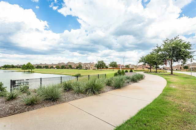 view of home's community featuring a yard and a water view