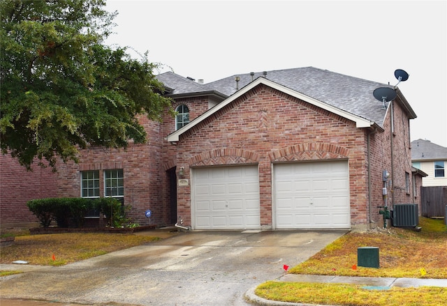 view of front of house featuring central AC unit and a garage