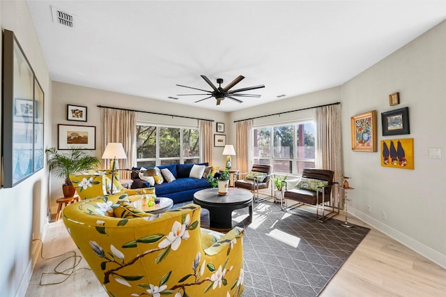 living room featuring hardwood / wood-style floors and ceiling fan