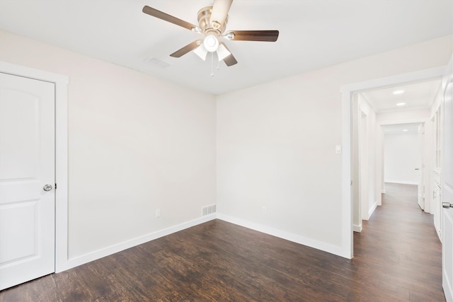 empty room with dark wood-type flooring and ceiling fan