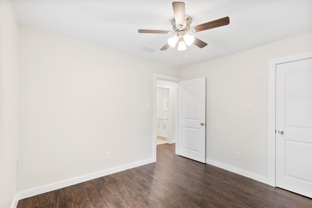 spare room featuring ceiling fan and dark hardwood / wood-style floors