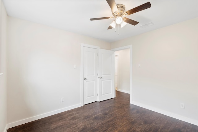 interior space featuring ceiling fan and dark hardwood / wood-style floors