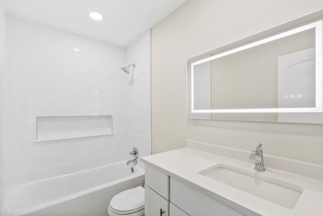 full bathroom featuring vanity, toilet, and tiled shower / bath combo