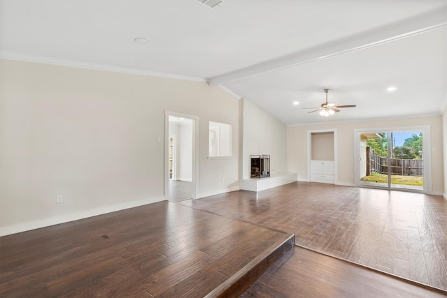 unfurnished living room with a ceiling fan, wood finished floors, a large fireplace, crown molding, and vaulted ceiling with beams