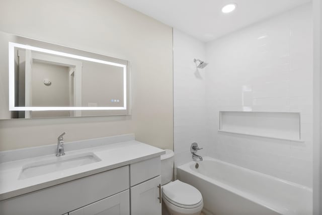 full bathroom with toilet, tiled shower / bath combo, and vanity