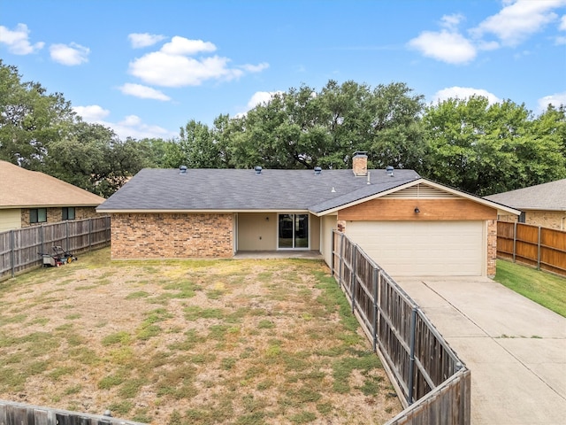 ranch-style home featuring a garage and a front yard