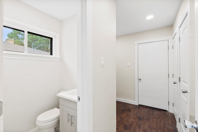 bathroom featuring vanity, toilet, and hardwood / wood-style flooring