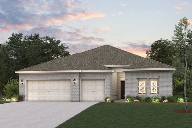 view of front of house with driveway, an attached garage, a shingled roof, a front lawn, and brick siding