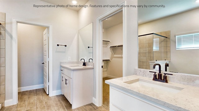 bathroom with vanity, a tile shower, and hardwood / wood-style floors