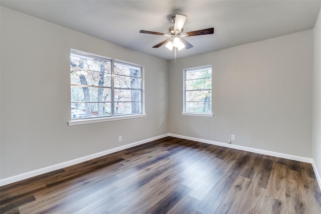 spare room with ceiling fan and dark hardwood / wood-style flooring