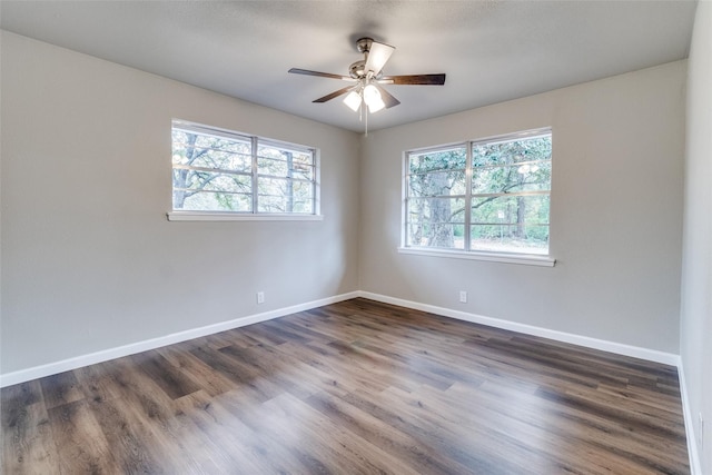 empty room with ceiling fan and dark hardwood / wood-style floors