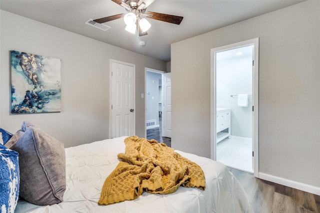 bedroom featuring hardwood / wood-style floors, ceiling fan, and connected bathroom