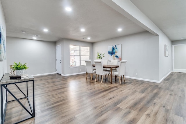 dining space featuring wood-type flooring