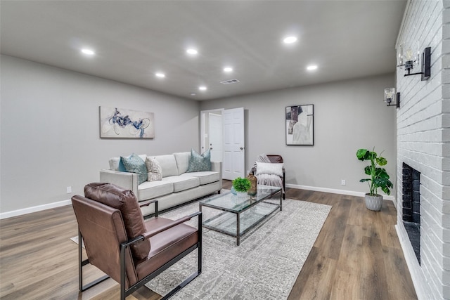 living room featuring dark hardwood / wood-style flooring and a fireplace