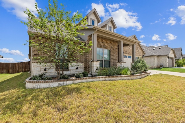 view of front of property featuring a garage and a front lawn