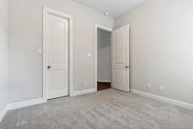 unfurnished bedroom with light carpet