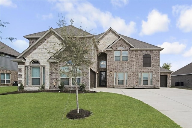 view of front of house with a garage and a front lawn